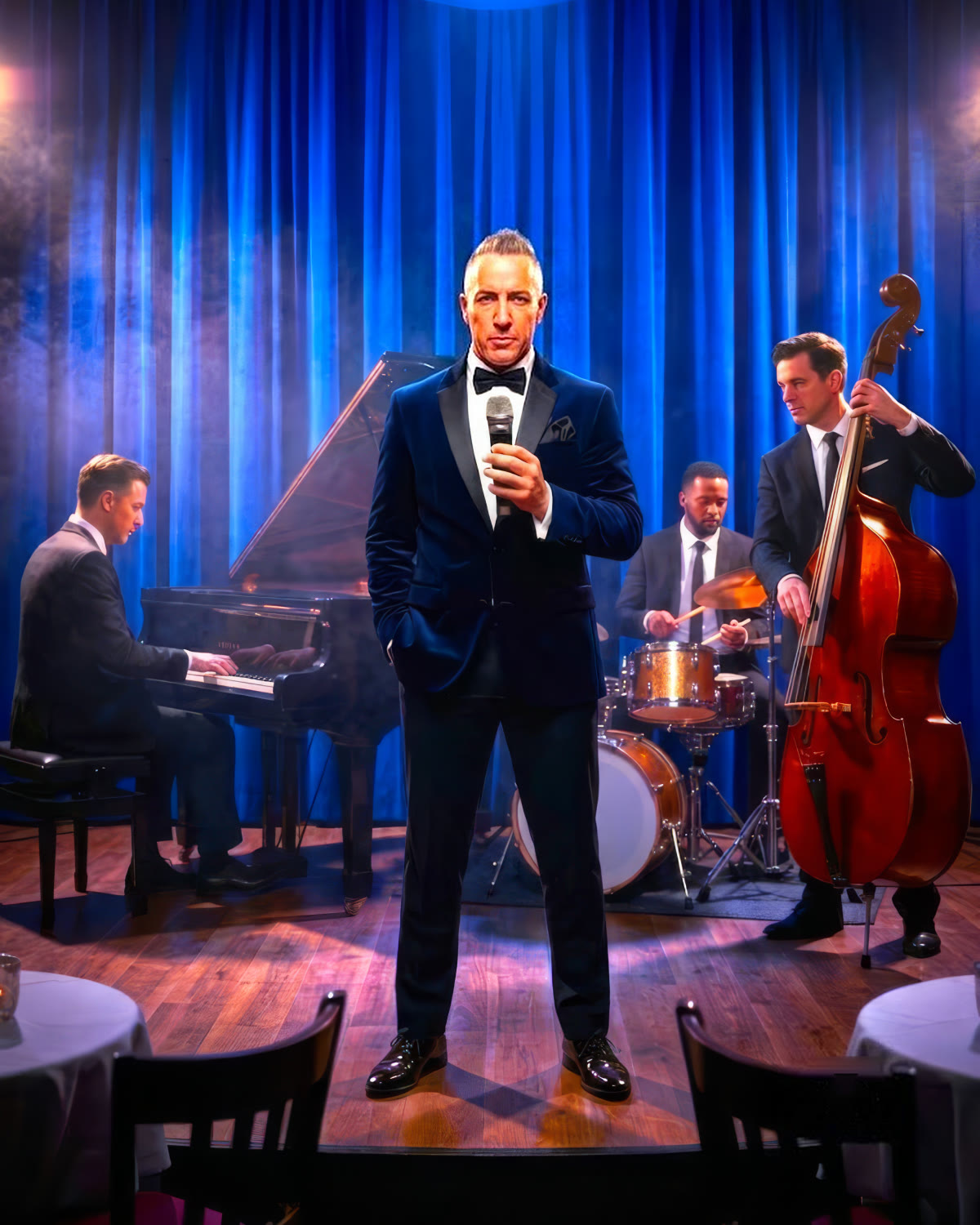 Barry Shaw at the microphone on a blue-lit stage, his trio playing behind him